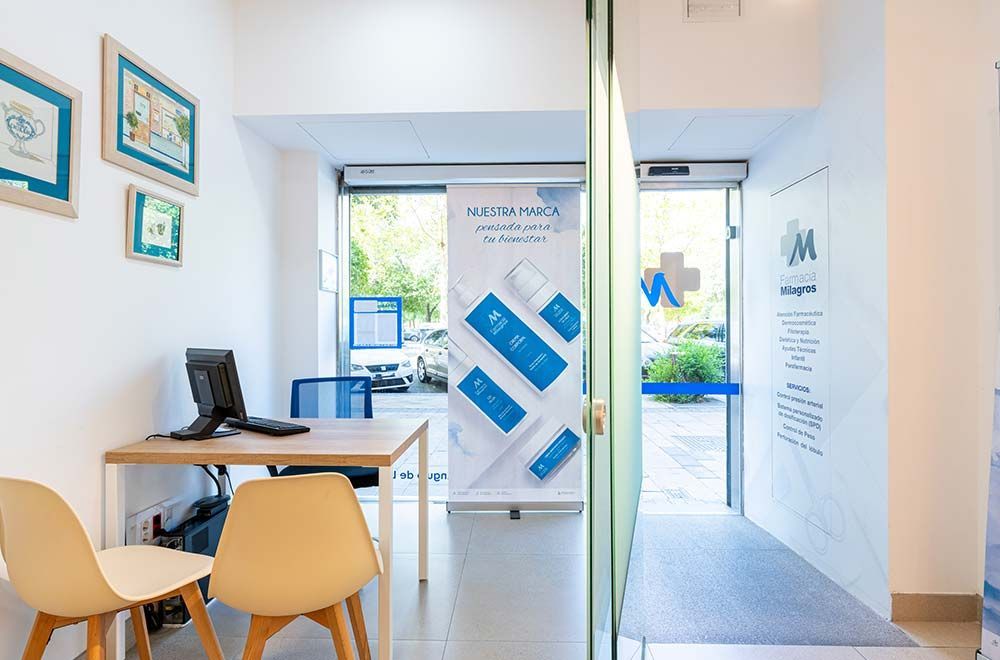 Una sala de espera con un escritorio, sillas y una computadora.