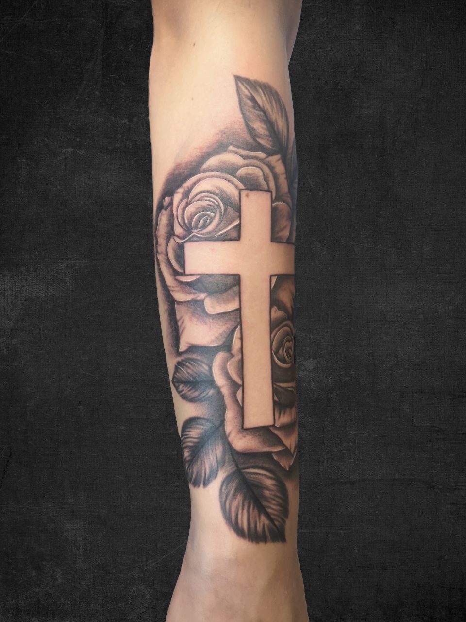 Kreuz-Tattoo in Schwarz und Grau auf dem Unterarm