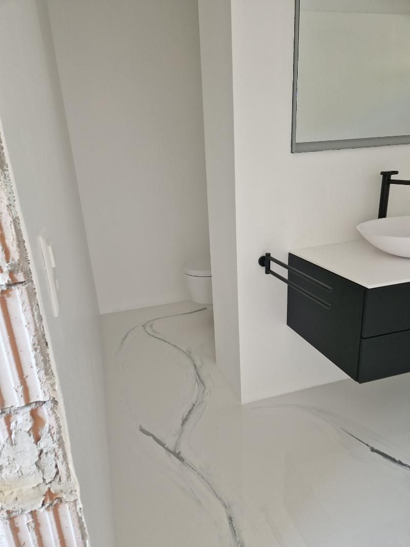 Ein Badezimmer mit Waschbecken, Toilette und Spiegel. Foto von der Popaj GmbH