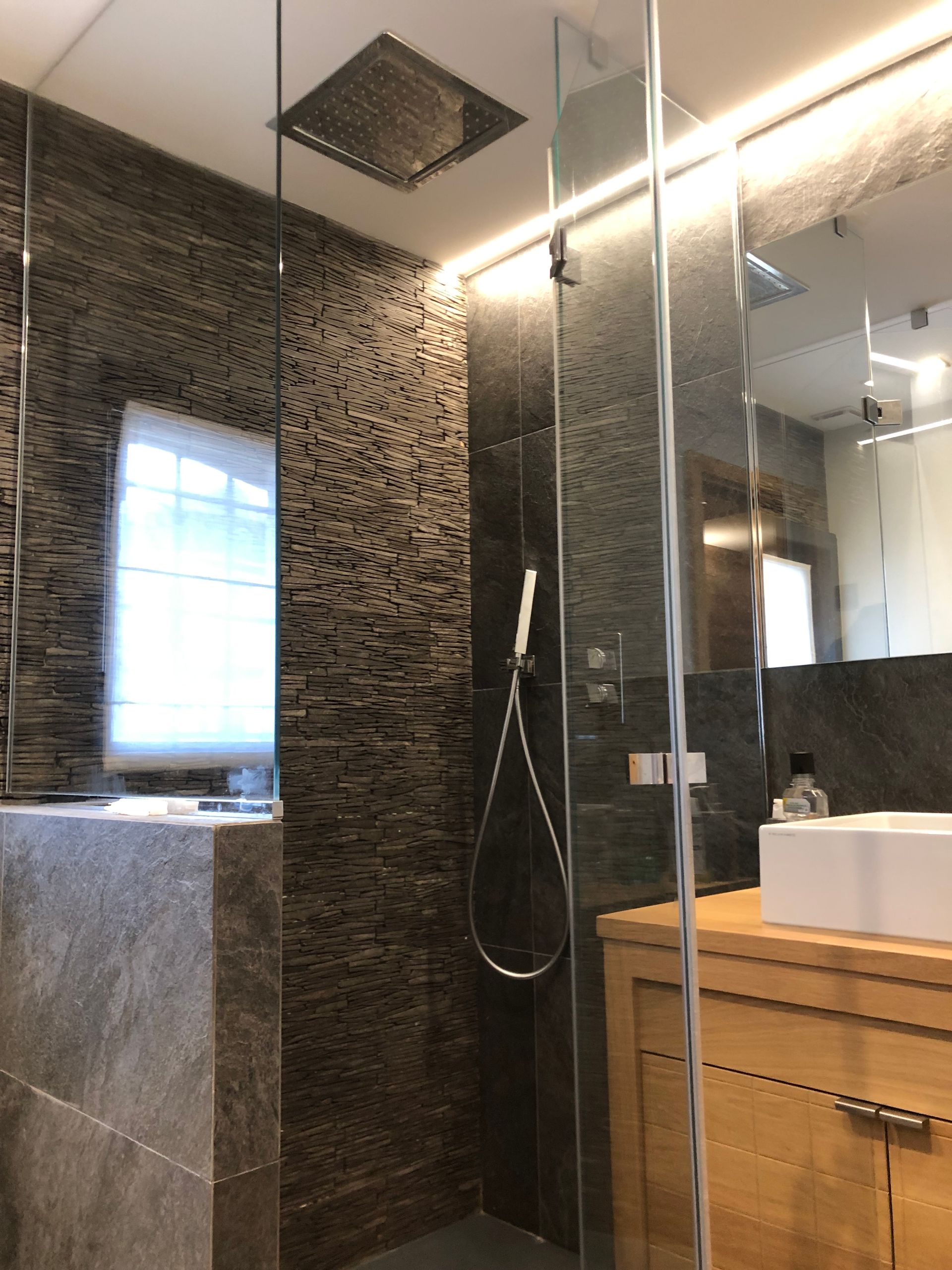 Cabine de douche en verre transparent à côté du bloc lavabo