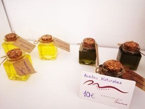 Una exhibición de pequeñas botellas de aceite con un cartel que dice aceites naturales.