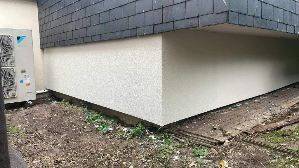 Angle de la partie basse d'une habitation en crépis.