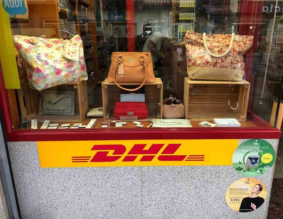 Un cartel de DHL está en el lateral de la ventana de una tienda.