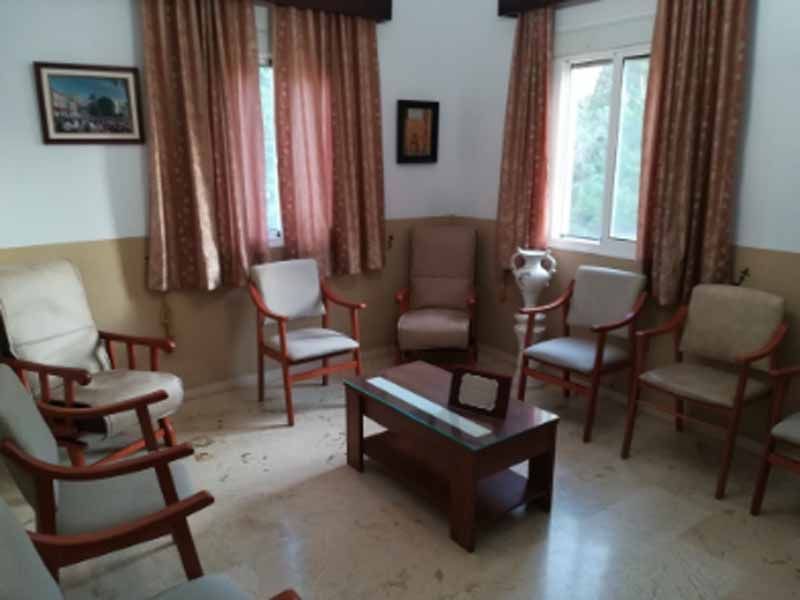 Una sala de estar con sillas y una mesa de café.