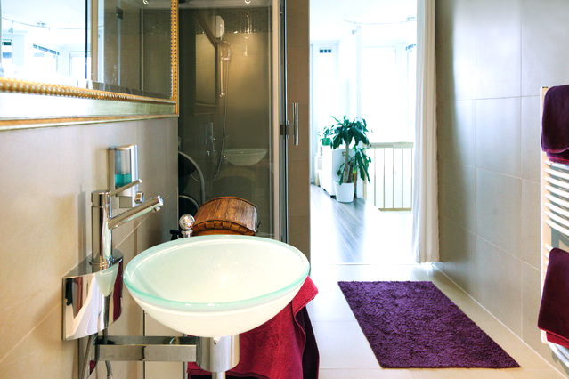 a bathroom with a sink and a purple rug