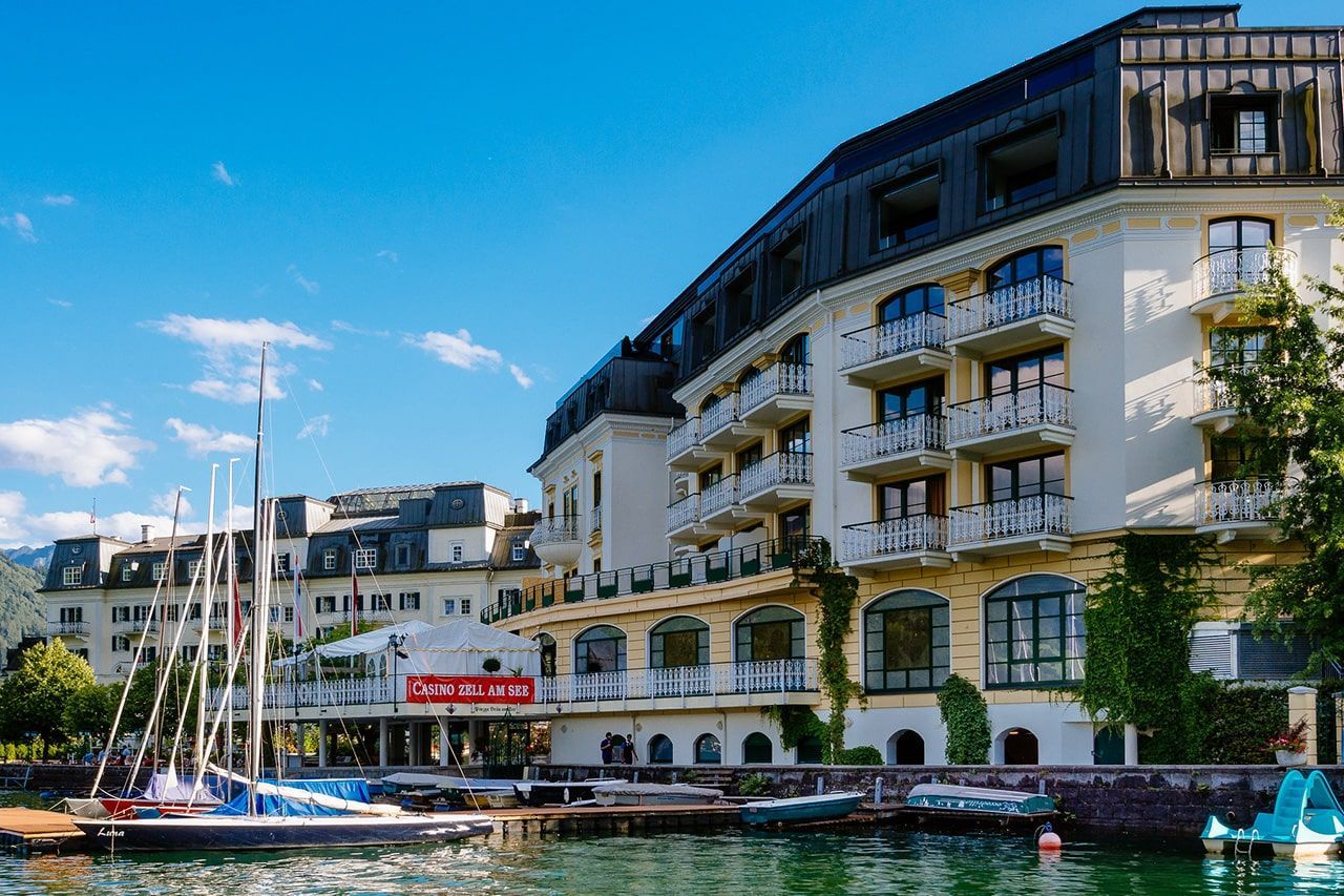 a large building next to a body of water with boats docked in front of it