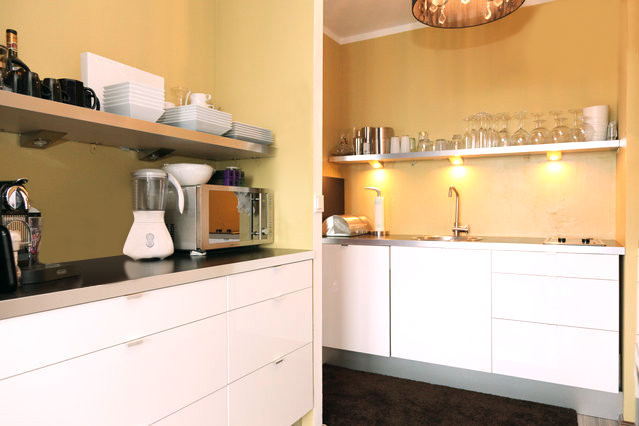a kitchen with white cabinets and a blender on the counter