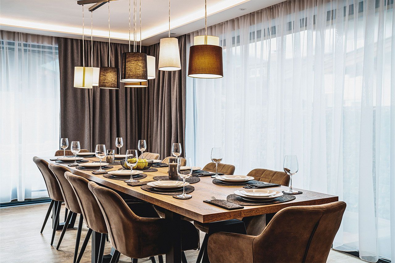 a dining room with a long table and chairs .