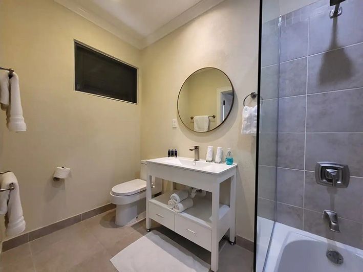 a bathroom with a sink , toilet , shower and bathtub .