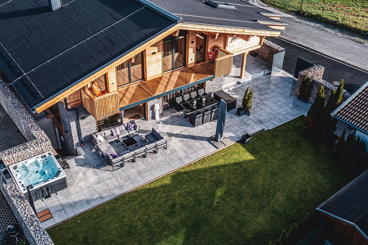 an aerial view of a house with a hot tub in the backyard .