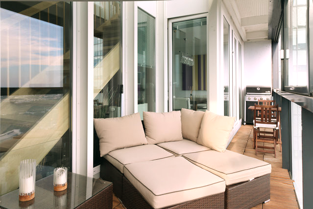 a balcony with a couch and a table with candles