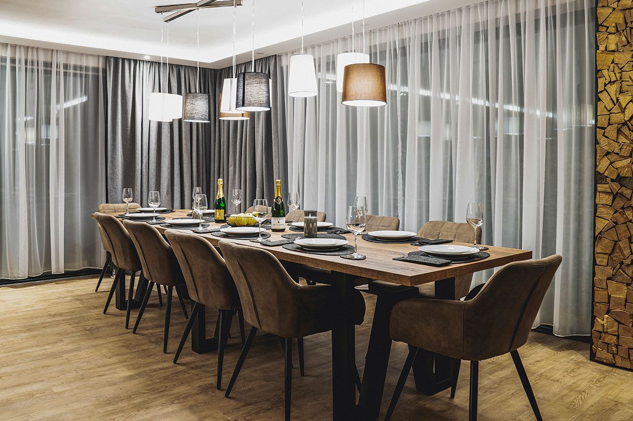 there is a long table and chairs in the room .