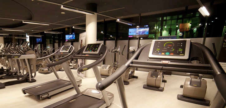 a gym with a lot of treadmills and exercise bikes