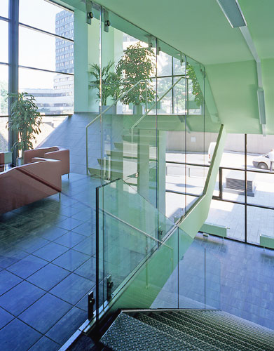 a staircase in a building with a glass railing