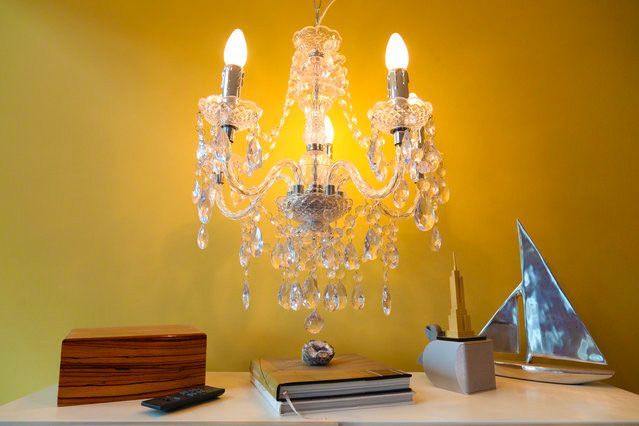 a chandelier is hanging from the ceiling above a table