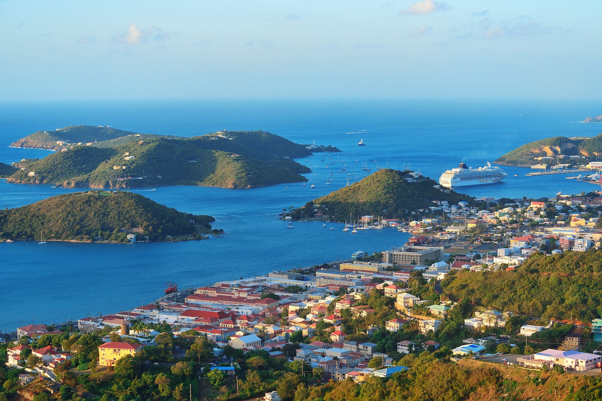 an aerial view of a city surrounded by water and mountains