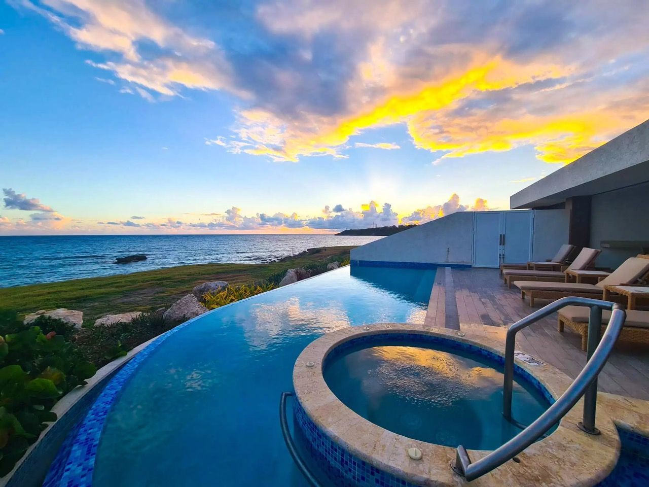 swimming pool with a hot tub in the middle of it