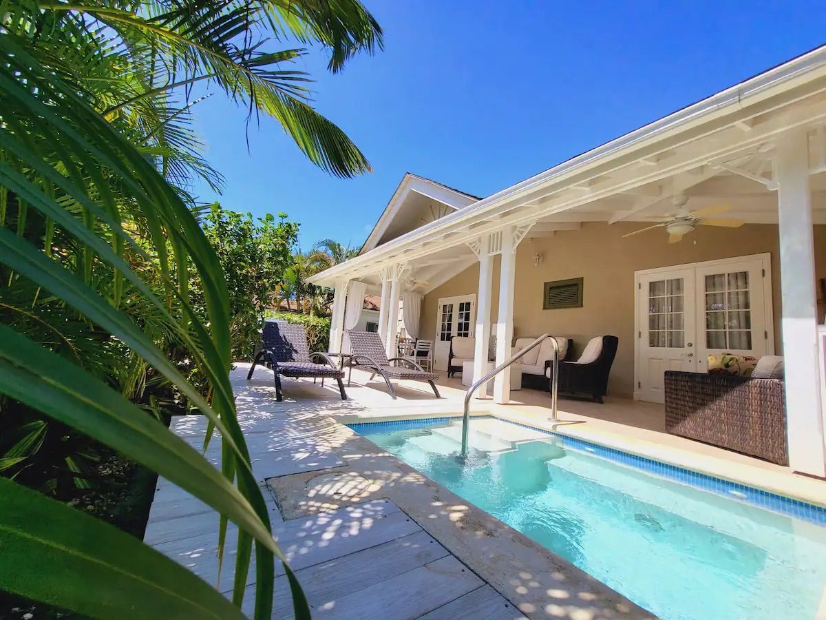 there is a large swimming pool in front of a house .