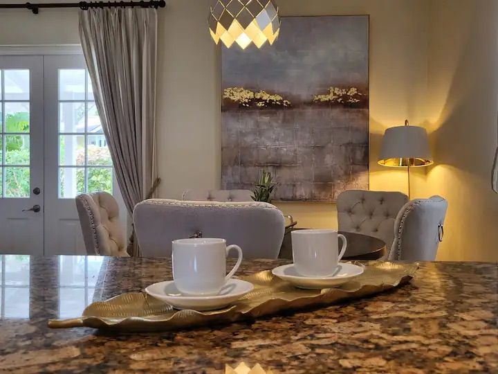 a kitchen counter with two cups and saucers on it .