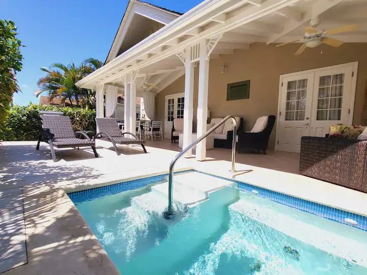 there is a swimming pool in the backyard of a house .