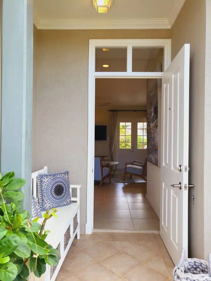a hallway with a bench and a door that is open
