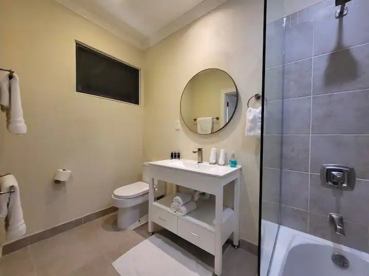 a bathroom with a sink , toilet , shower and bathtub .