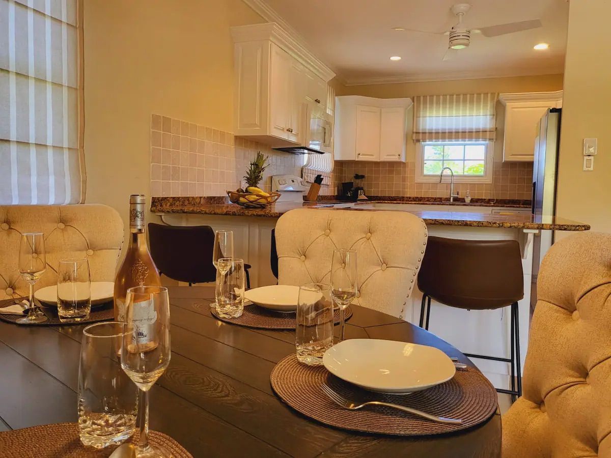 a dining room table with plates and glasses on it