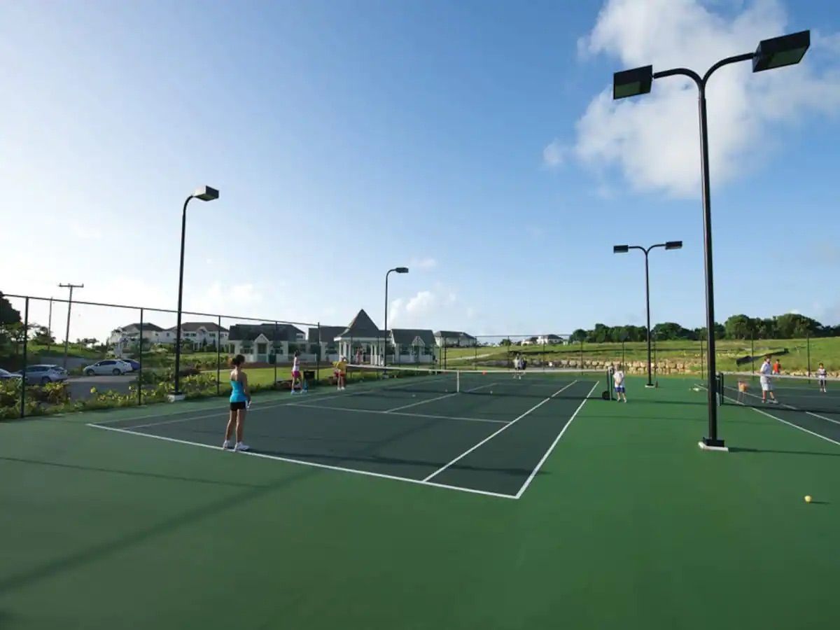 a group of people are playing tennis on a tennis court .