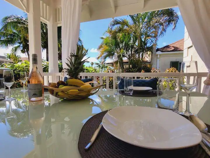 a table with plates , utensils , and a bottle of wine on it .