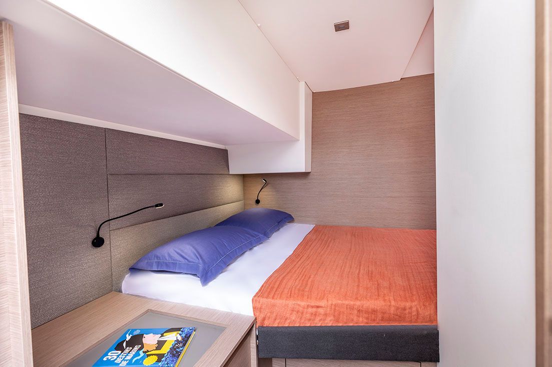 a bedroom with a large bed and a magazine on the nightstand