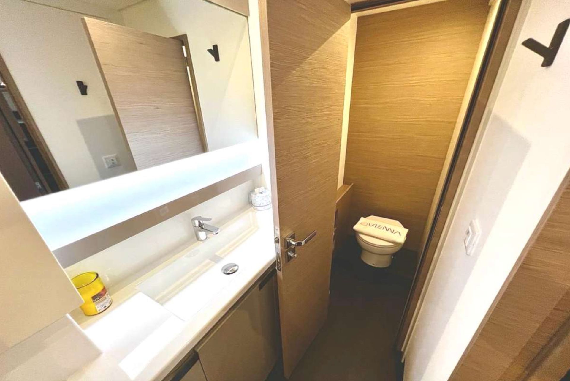 a bathroom with a sink, toilet and mirror