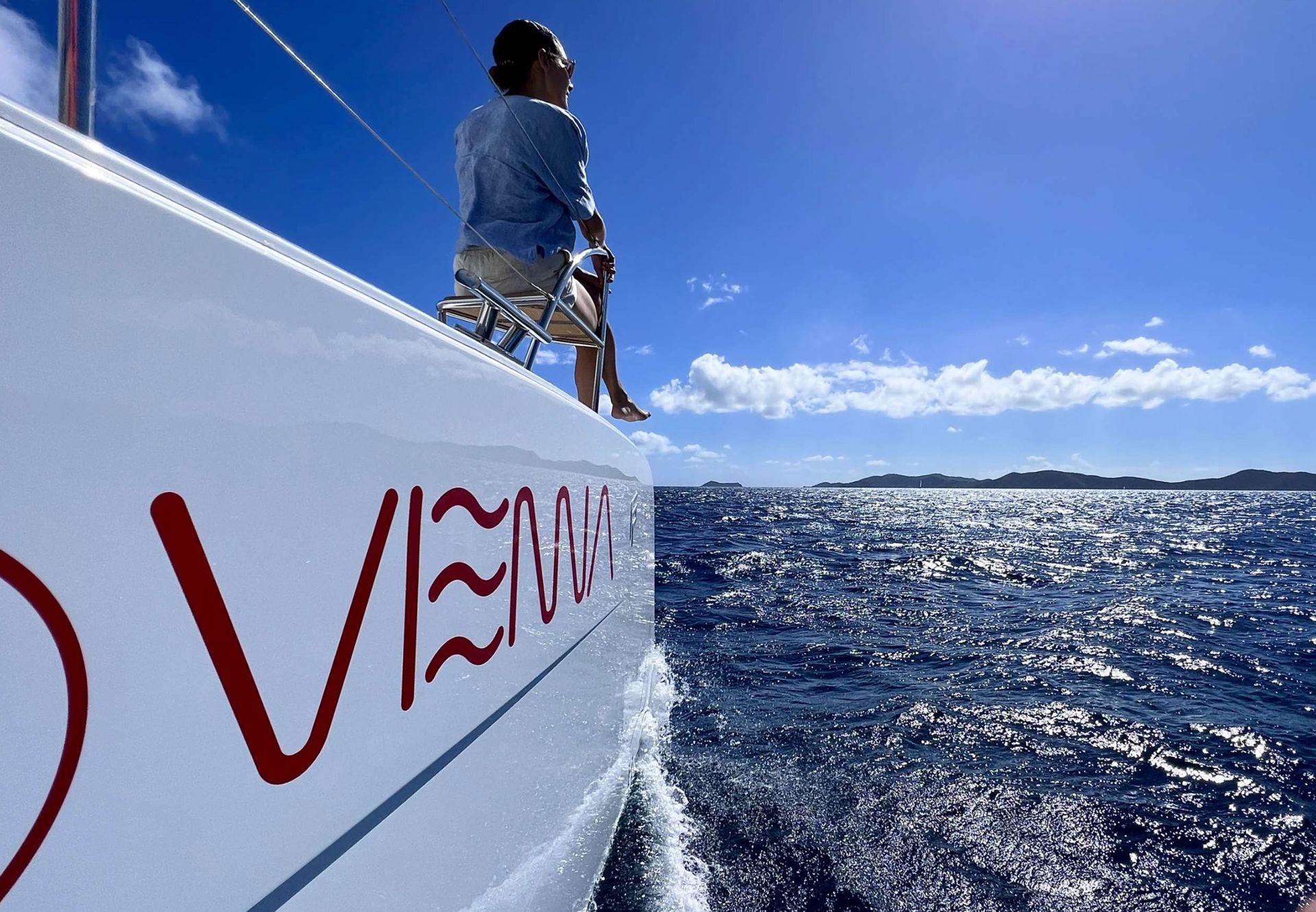 a person is sitting on the side of a boat that says vema