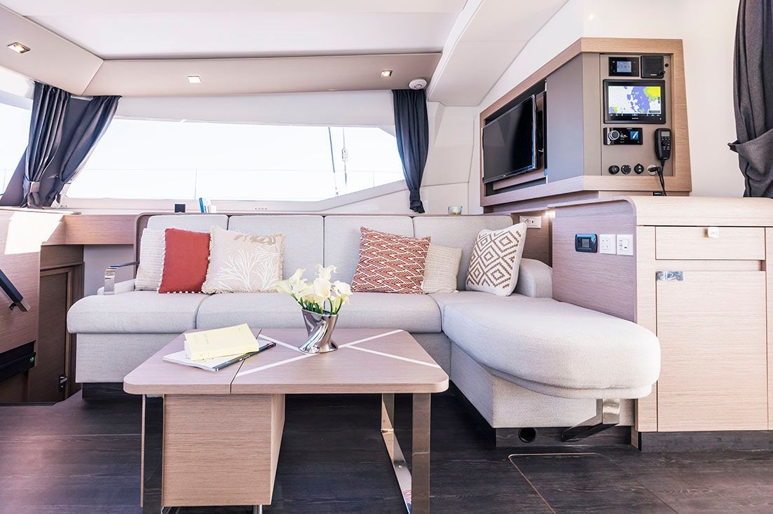 a living room on a boat with a couch, table and television