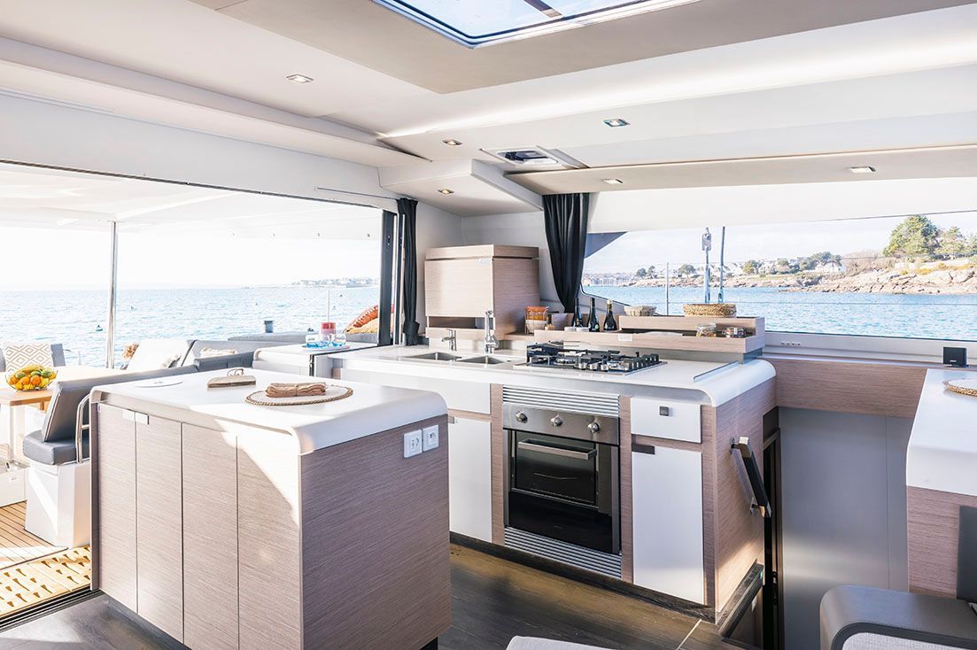 a kitchen on a boat with a view of the ocean