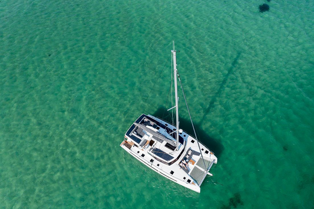 an aerial view of a sailboat in the ocean .