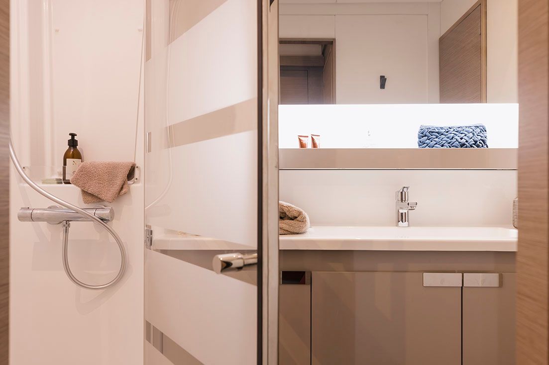 a bathroom with a sink , shower and mirror .