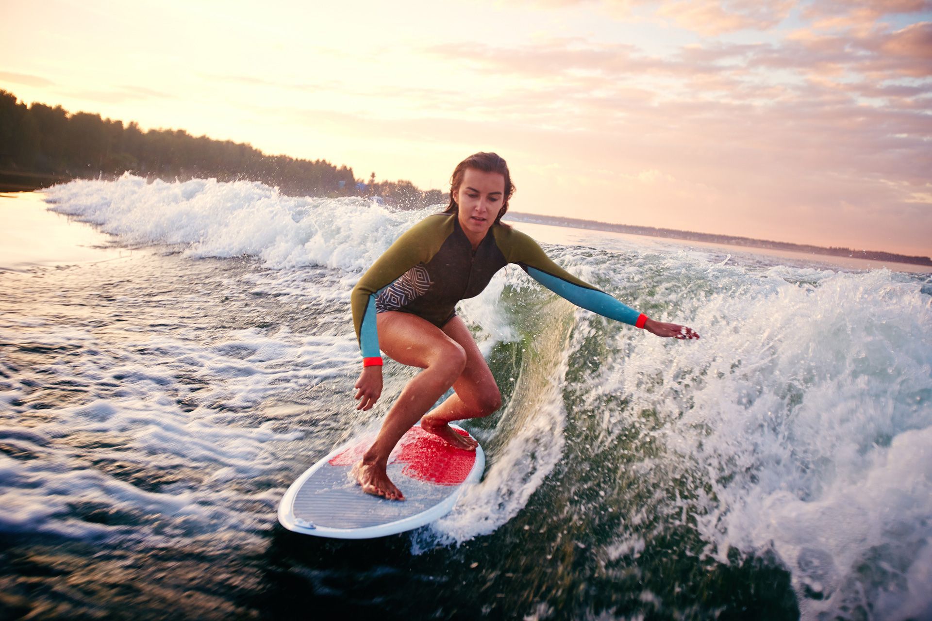 a woman is riding a wave on a surfboard in the ocean
