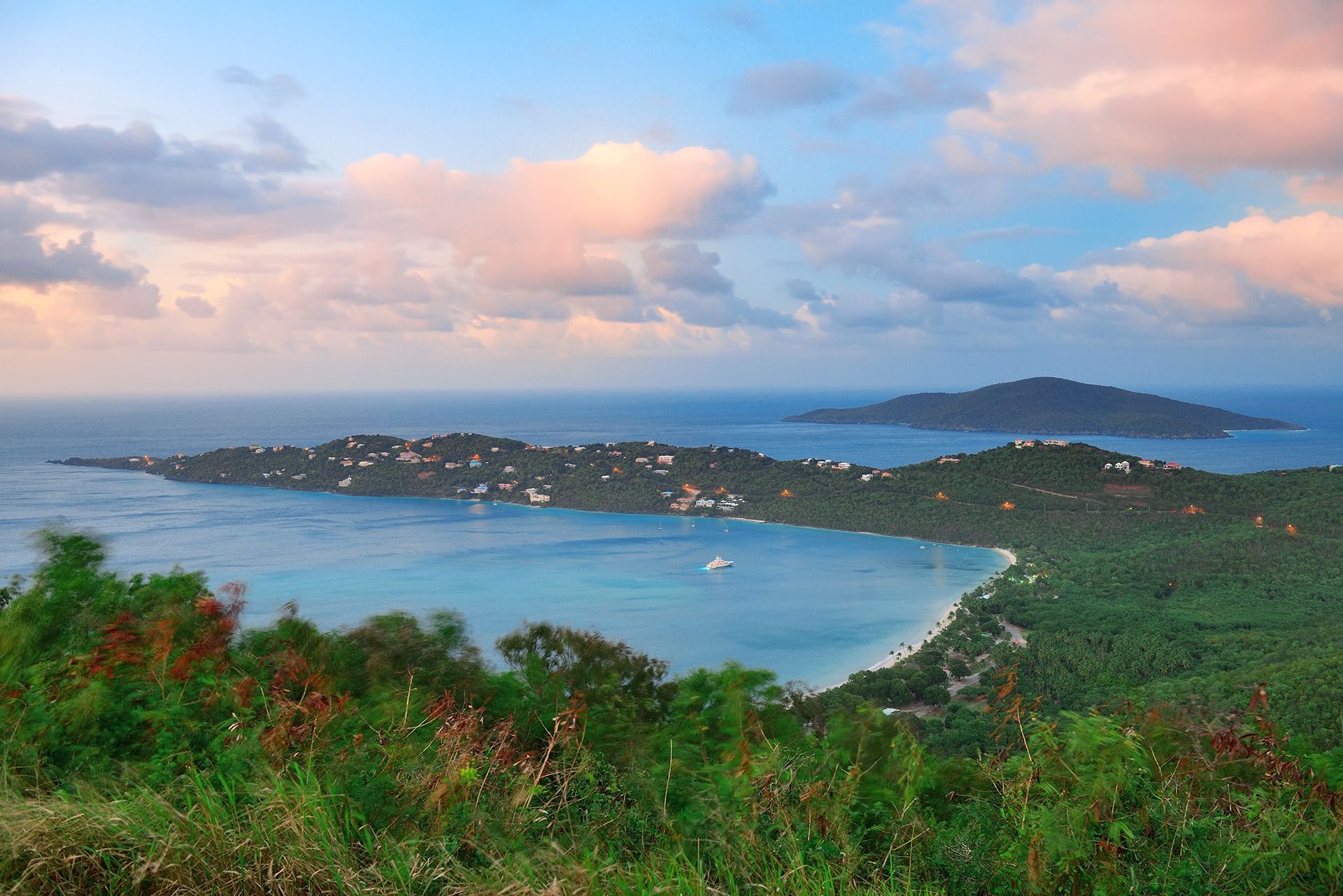 a view of a small island in the middle of a large body of water .