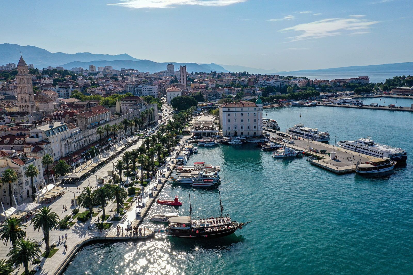 an aerial view of a harbor with boats and a city in the background