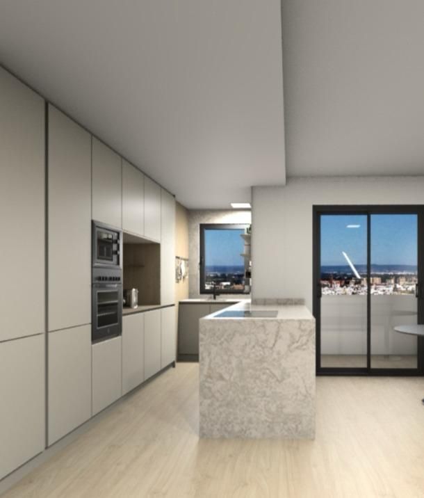 Una cocina con gabinetes blancos y una isla grande.