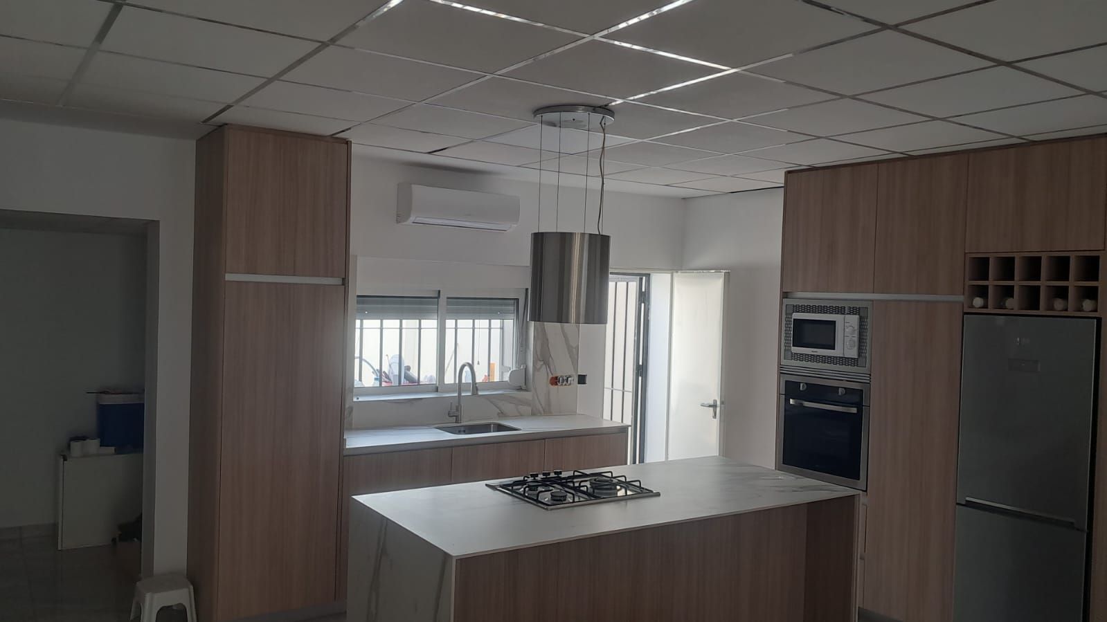 Una cocina con una gran isla blanca en el medio.