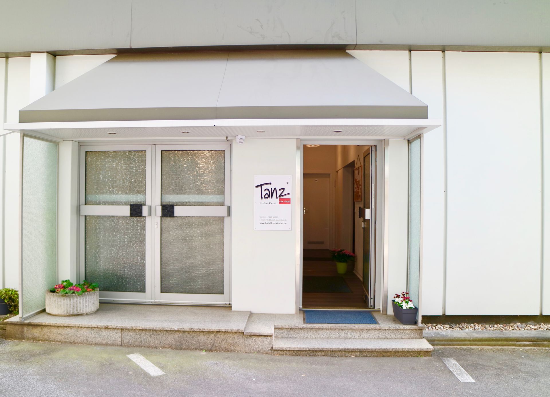 Ein weißes Gebäude mit einem Schild mit der Aufschrift.