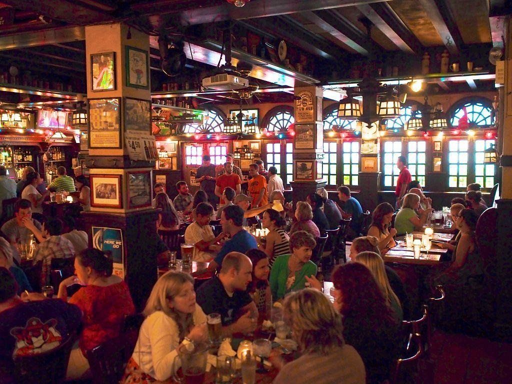 A large group of people are sitting at tables in a restaurant
