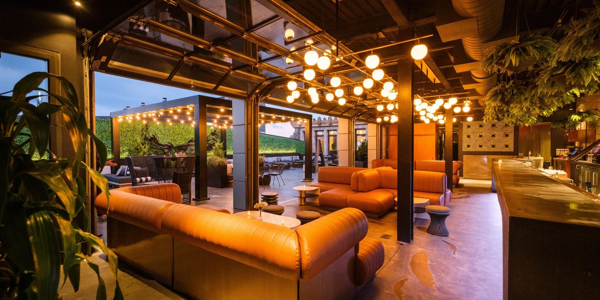 A large room with a lot of furniture and lights on the ceiling.