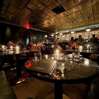 A group of people are sitting at tables in a restaurant.