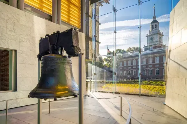 The liberty bell is on display in front of a building.