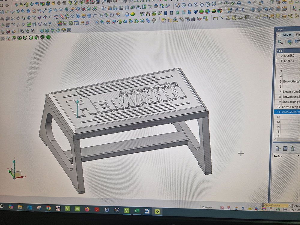 3D-Modell eines kleinen, rechteckigen Tritthockers mit dem Schriftzug „HEIMANN“ auf der Oberseite.