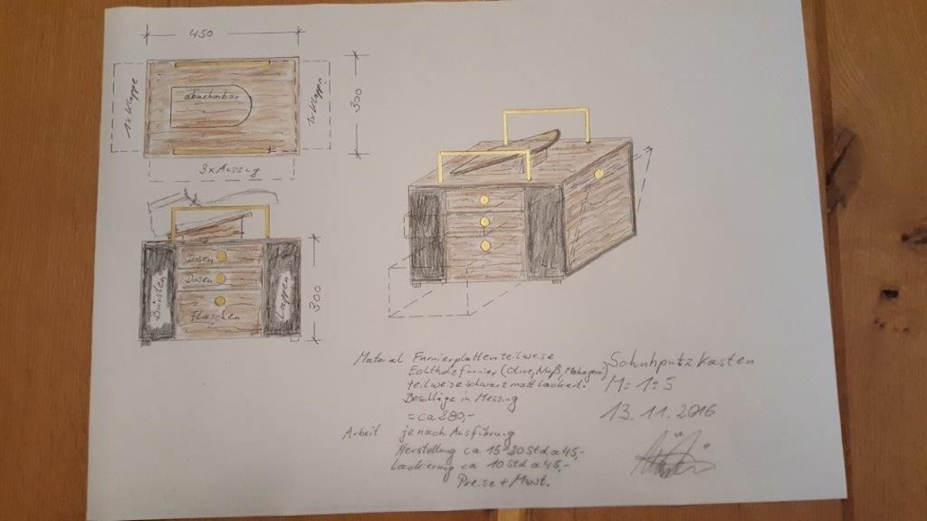 Eine Zeichnung einer Holzkiste mit Griffen auf einem Holztisch.