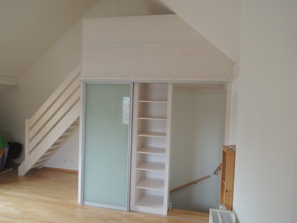 Ein Wohnzimmer mit einer Treppe und einer Glasschiebetür.