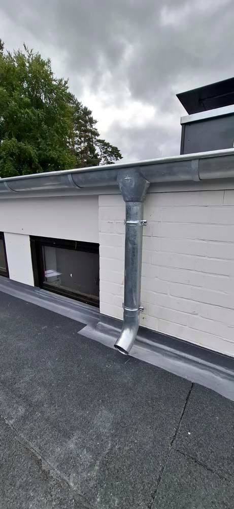 Eine Nahaufnahme einer Dachrinne an der Seite eines Gebäudes.